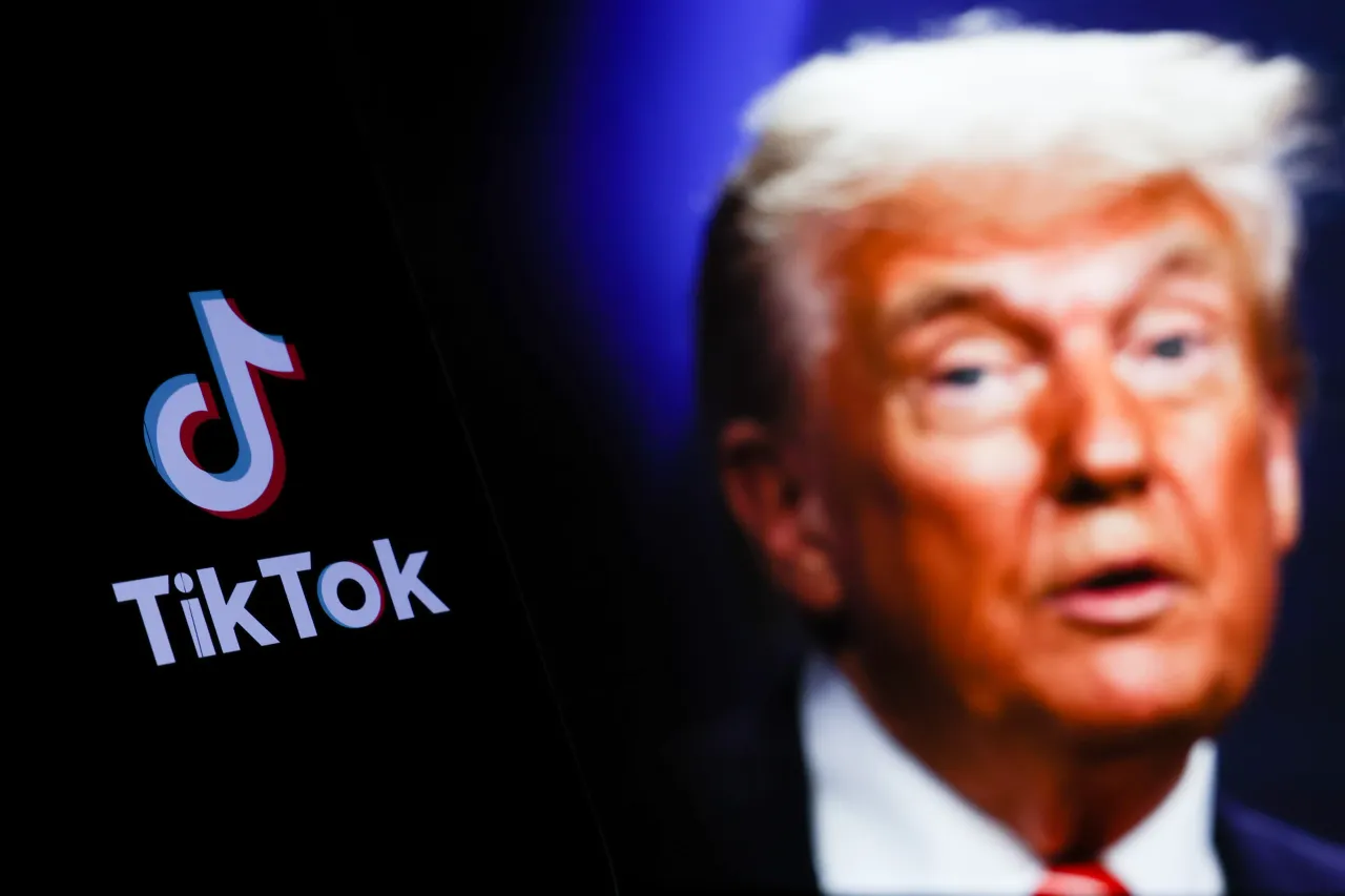 TikTok logo displayed on a phone screen and photo of Donald Trump taken on June 25 in The Hague. (Photo by Jakub Porzycki/NurPhoto via Getty Images)