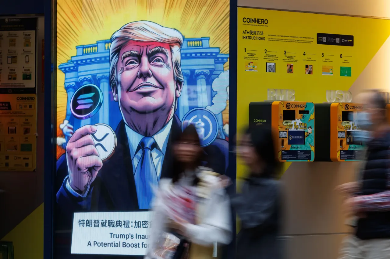 People walk past an advertisement feature Donald Trump with Solana, XRP, USDC Bitcoin in Hong Kong. (Photo by May James/SOPA Images/LightRocket via Getty Images)