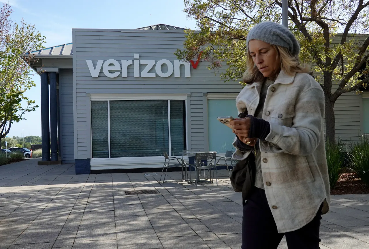 A pedestrian walks by a Verizon store on April 22, 2025 in Corte Madera, California. (Photo by Justin Sullivan/Getty Images)