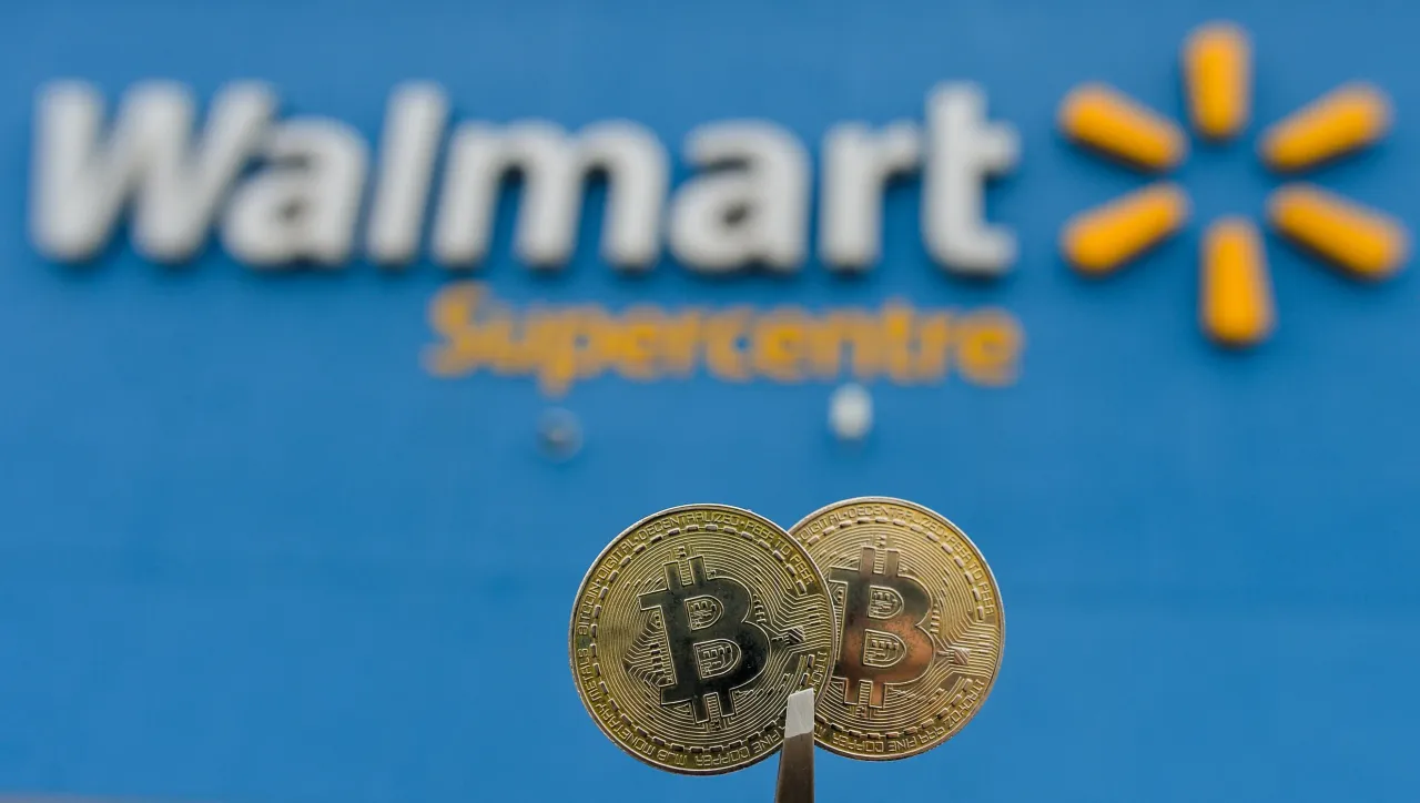 Two commemorative bitcoins hold in front of a Walmart logo outside a store in Edmonton on Tuesday, January 12, 2021. (Photo by Artur Widak/NurPhoto via Getty Images)