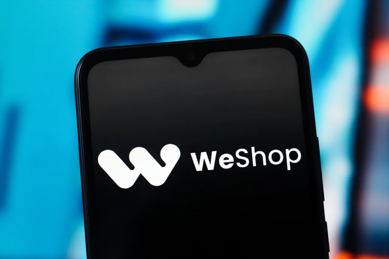 In this photo illustration, the WeShop (We Shop) logo is seen displayed on a smartphone screen. (Photo Illustration by Thomas Fuller/SOPA Images/LightRocket via Getty Images)