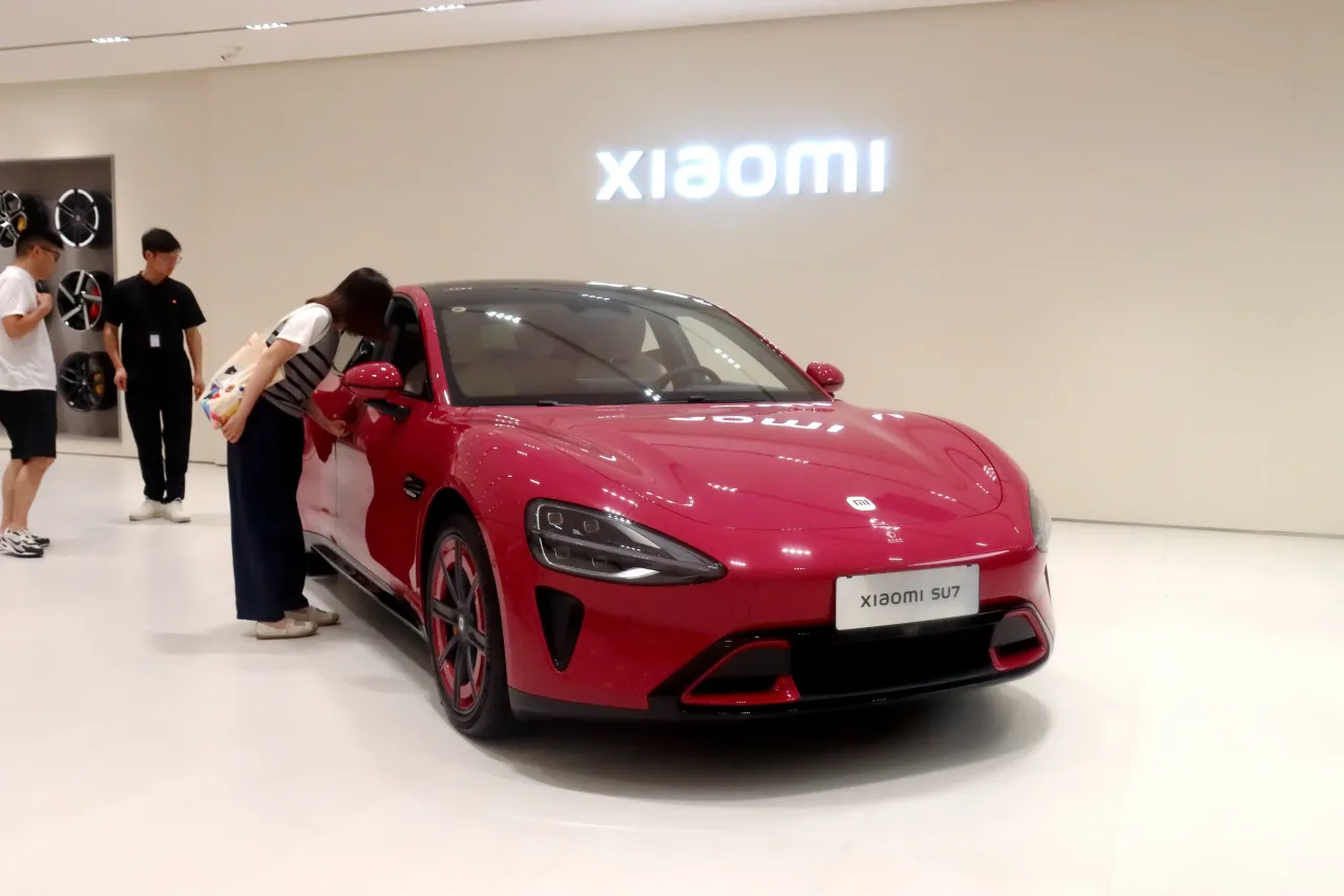Citizens choose a Xiaomi electric car SU7 in a store in Yichang, Hubei Province, China on July 19, 2025. (Photo credit should read CFOTO/Future Publishing via Getty Images)