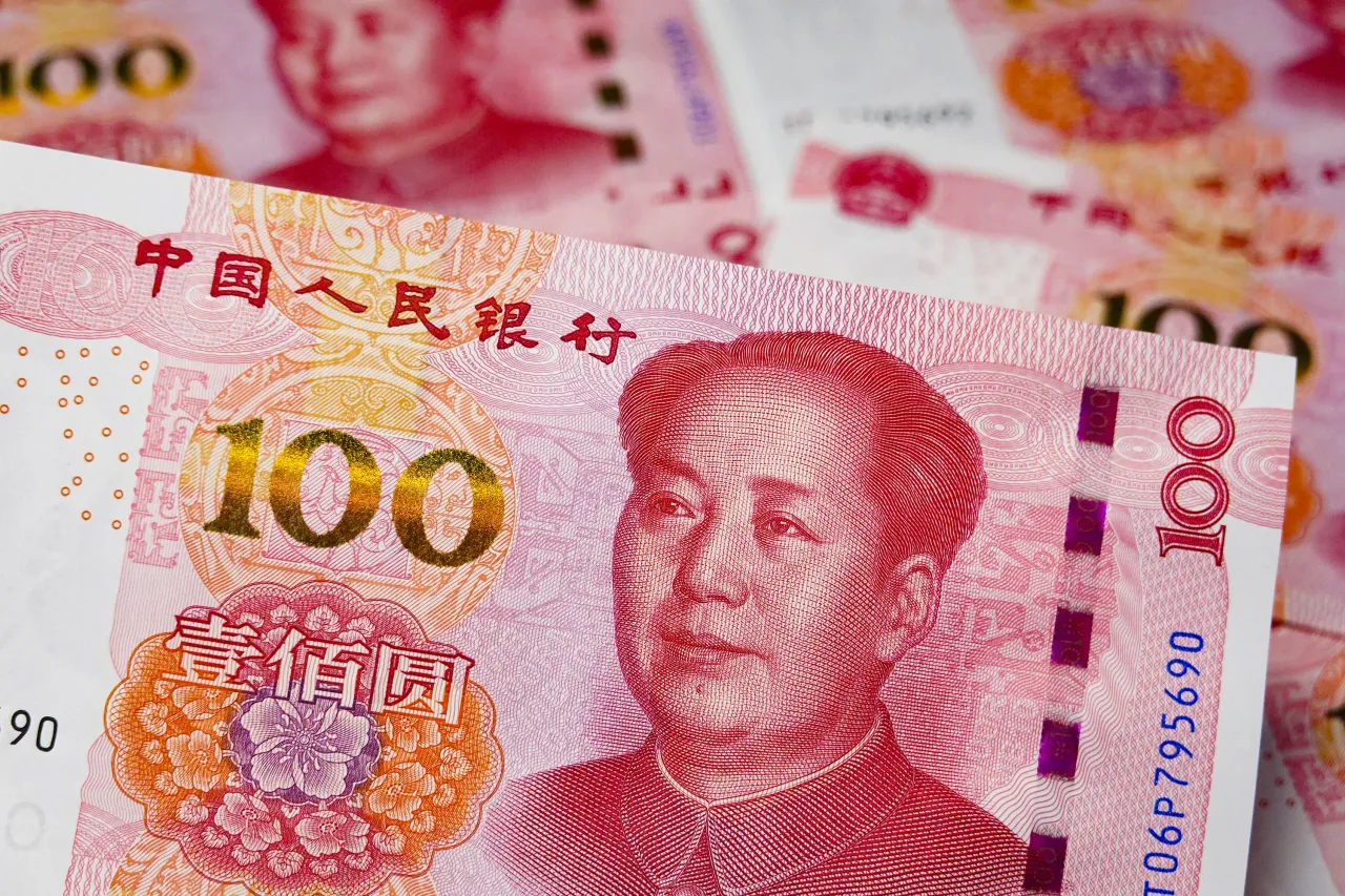 In this photo illustration, a 100 - yuan Renminbi banknote is in the foreground. (Photo Illustration by Sheldon Cooper/SOPA Images/LightRocket via Getty Images)