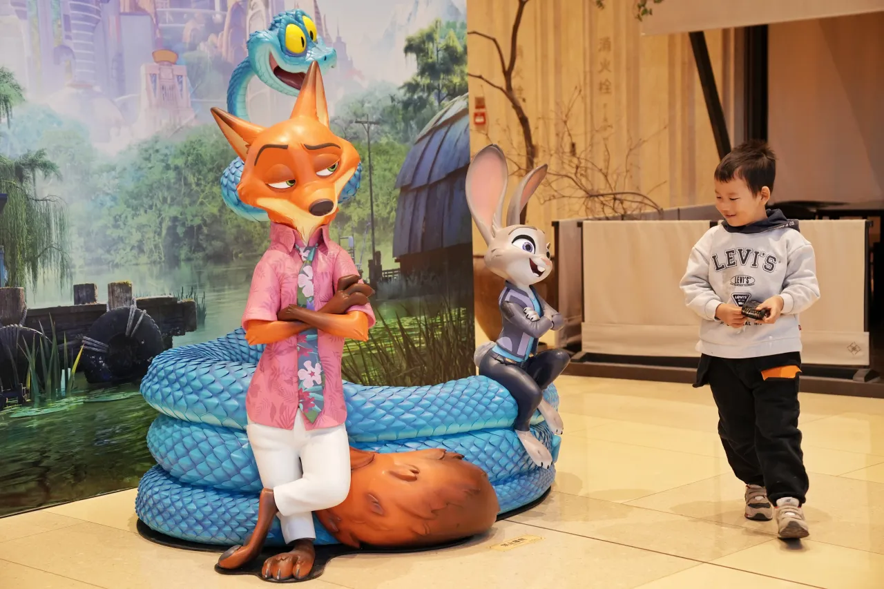 Zootopia 2-themed installations at a pop-up store draw a child at Guomao shopping mall on December 2, 2025 in Beijing, China. (Photo by Zhang Xiangyi/China News Service/VCG via Getty Images)