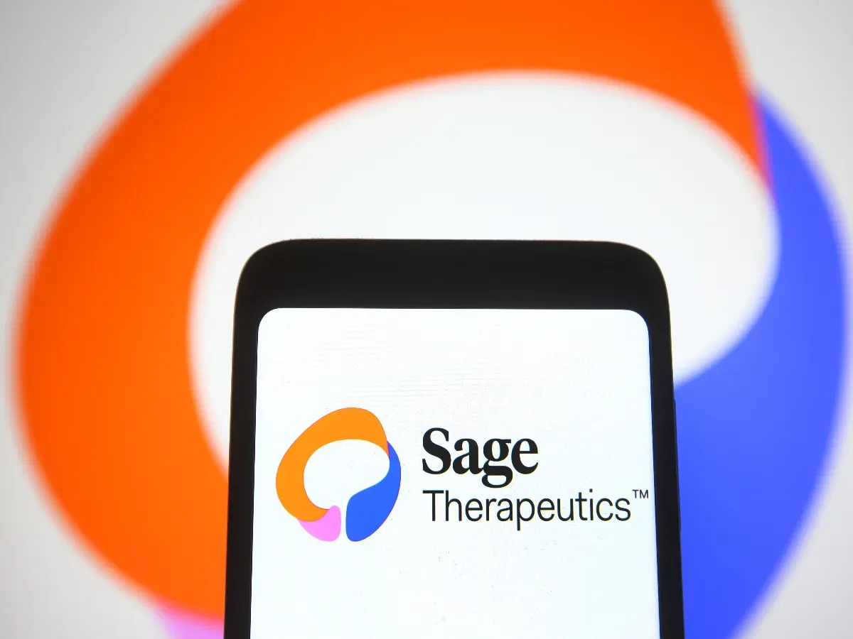 In this photo illustration, the Sage Therapeutics logo of a biopharmaceutical company seen on a smartphone and on a pc screen. (Photo Illustration by Pavlo Gonchar/SOPA Images/LightRocket via Getty Images)