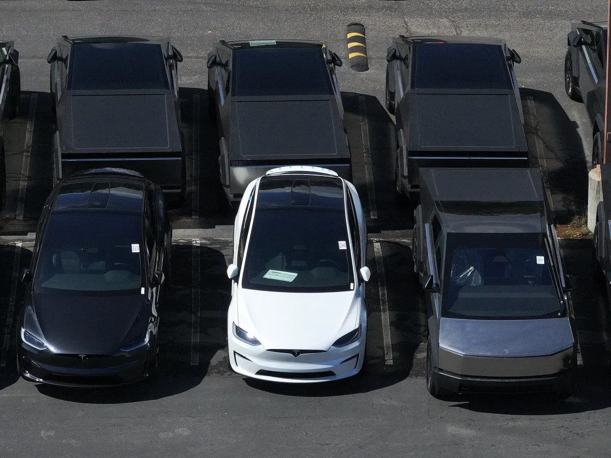 In an aerial view, brand new Tesla cars sit parked in a lot at a Tesla dealership on April 02, 2025 in Corte Madera, California. (Photo by Justin Sullivan/Getty Images)