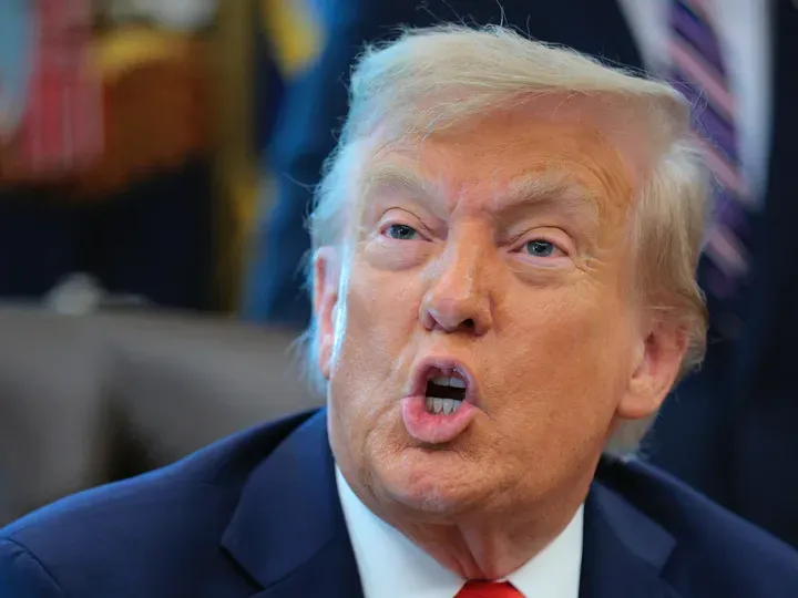 Donald Trump talks to journalists after signing executive orders in the Oval Office at the White House on August 25, 2025 in Washington, DC. 