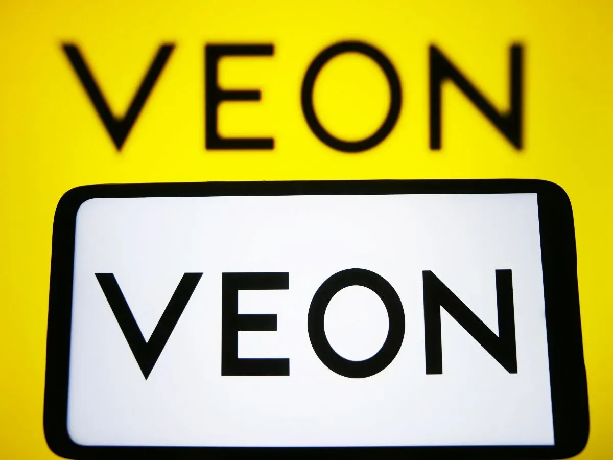 In this photo illustration, VEON Ltd. logo is seen on a smartphone and on a pc screen. 
